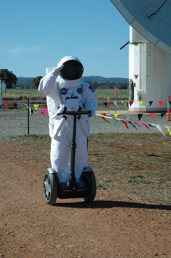 Actor in US space suit riding Segway near 12 metre telescope