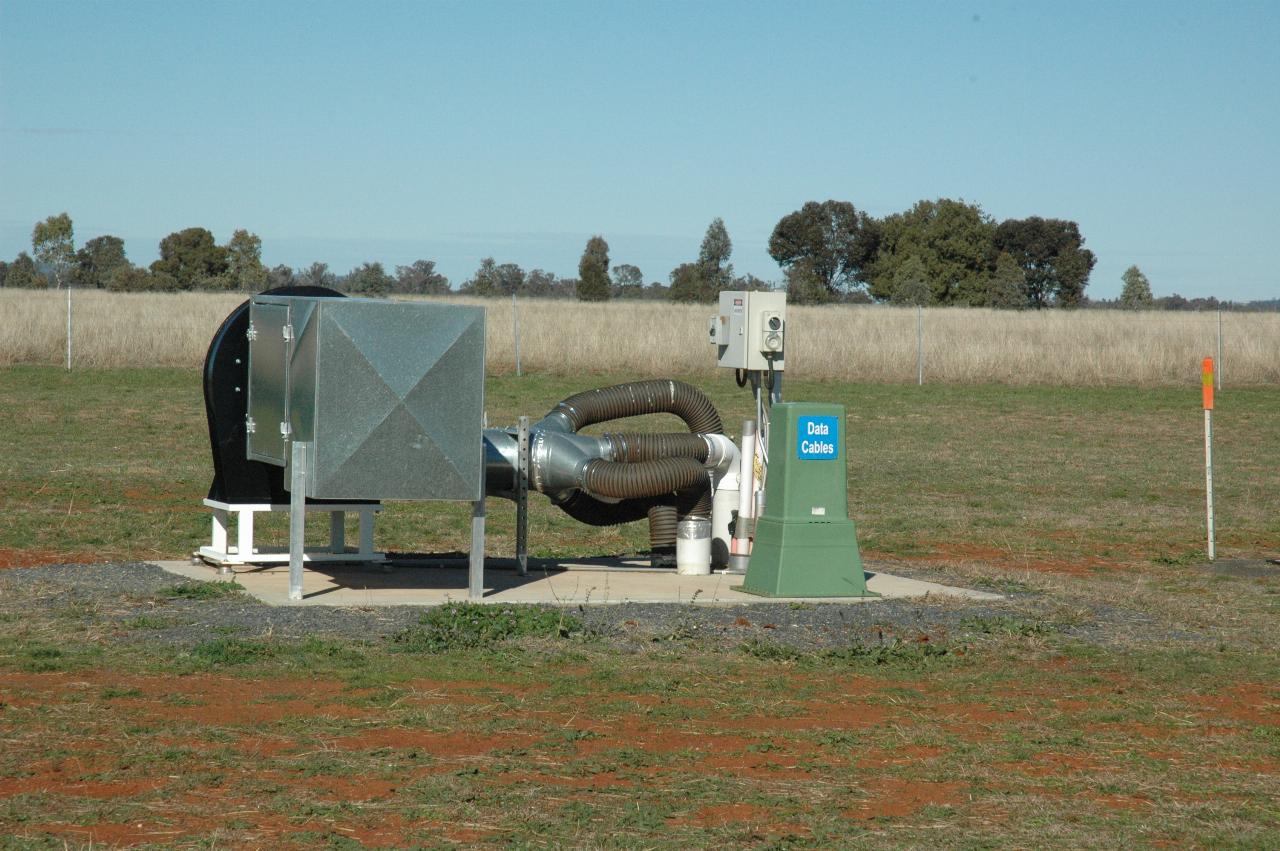 Pump with pipes to underground out in middle of field