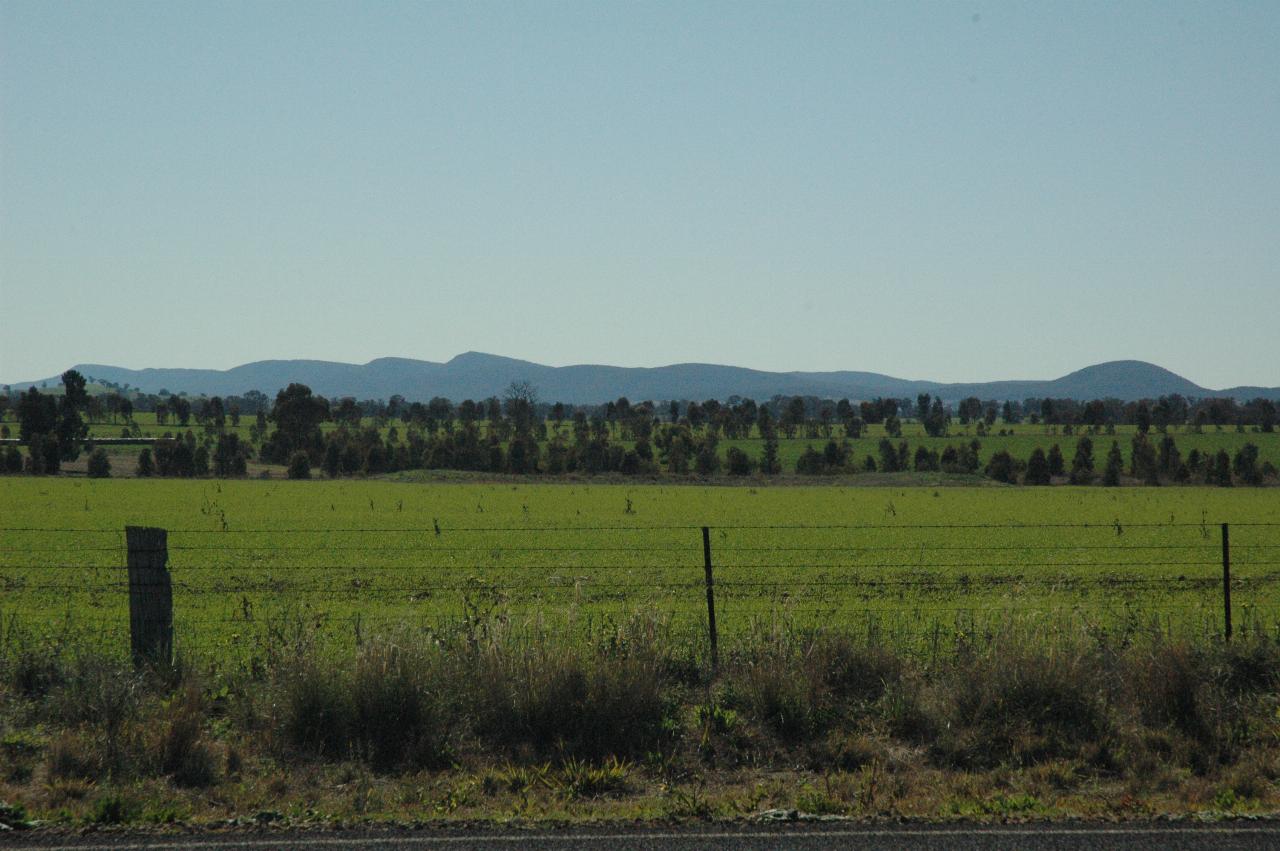 Distant blue hills over vivid green fields