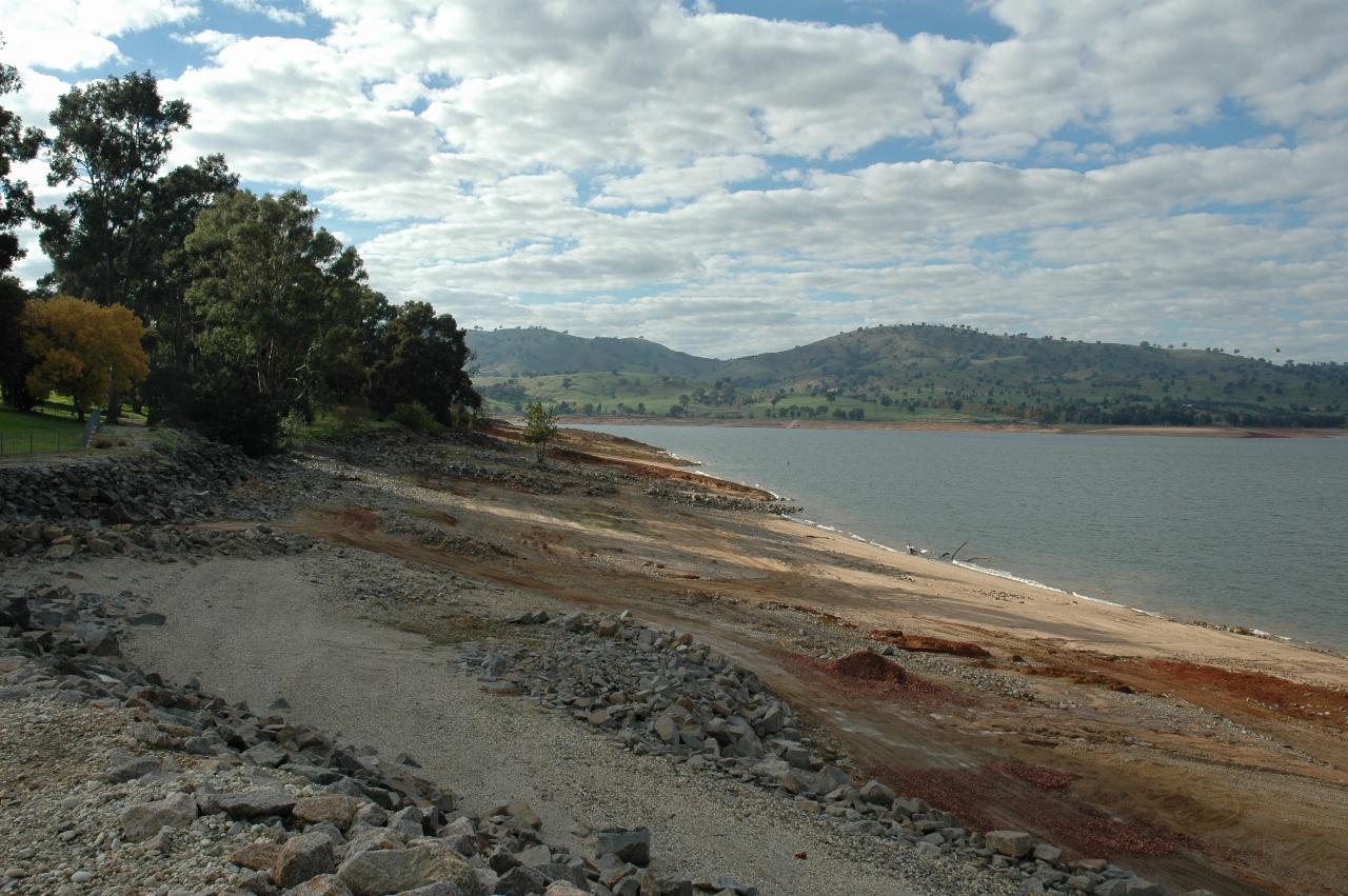 Low water level exposes much river bank, distant hills