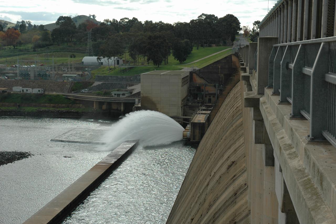 Fan shaped water release, power station and grassy area further back