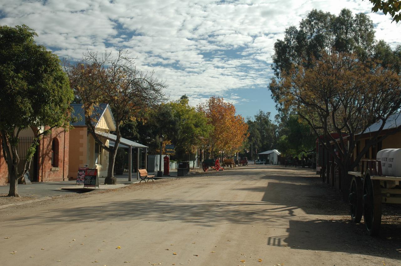 Dirt road with historic flavour and items, including buildings