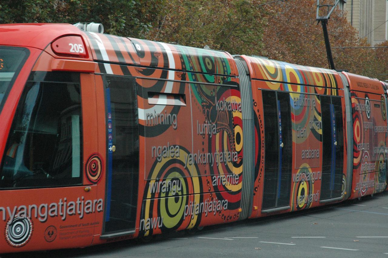 Tram car, painted an ochre colour, with Aboriginal motif and tribal names