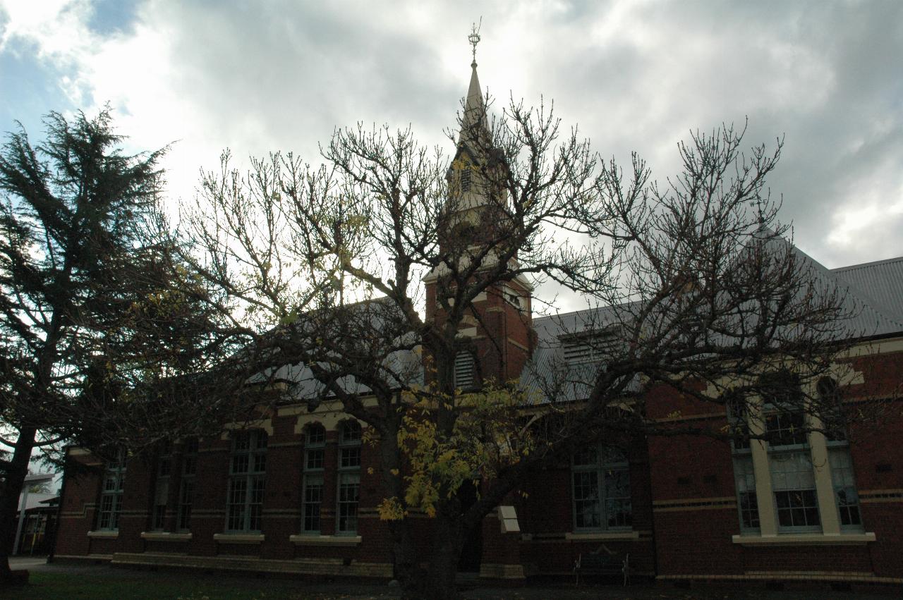 Ornate brick school building, including a clock tower