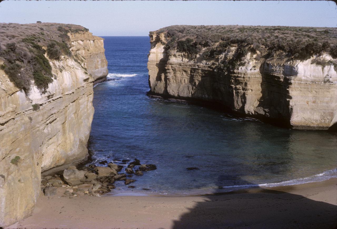 Narrow inlet with limestone cliffs and sandy beach