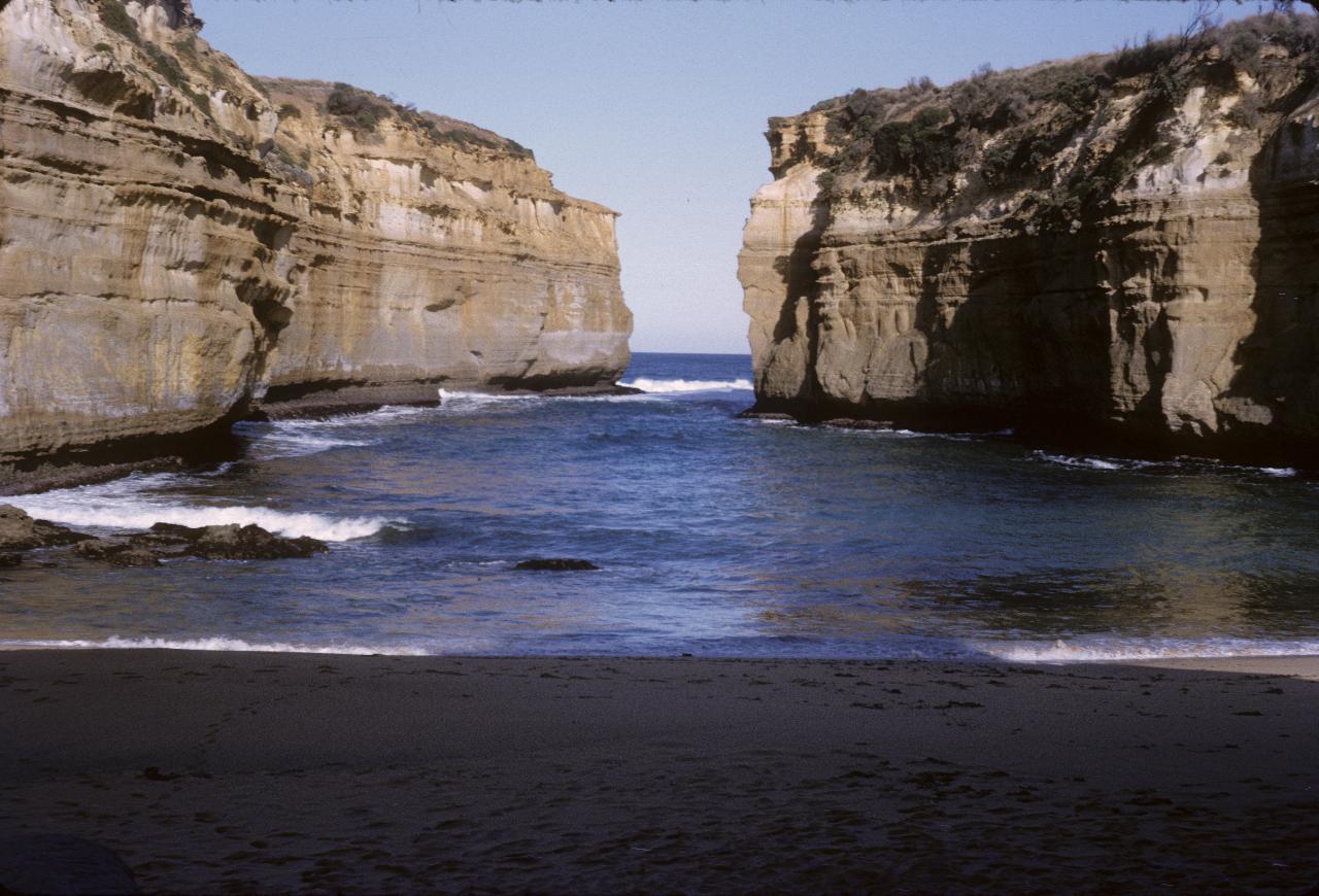 Narrow inlet viewed from beach, showing erosion of cliffs by the sea