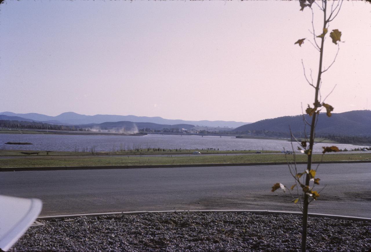 View over lake to bridge and distant mountains