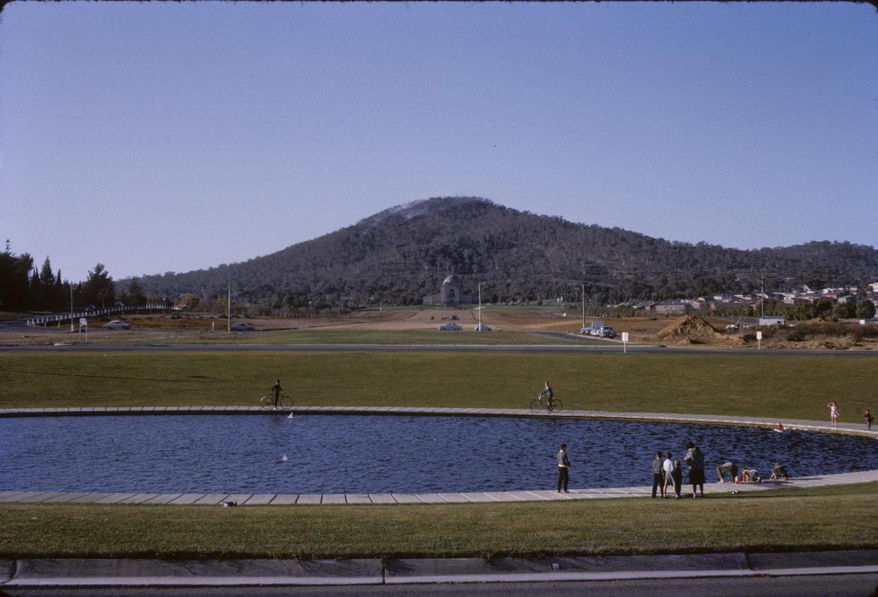 Circular pond, leading to construction zone to domed building to mountain