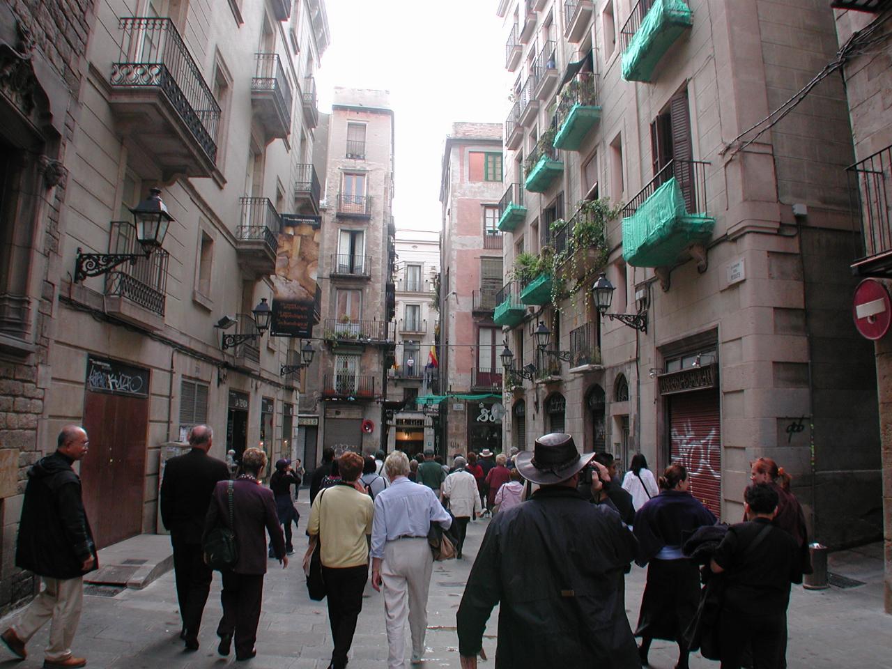 Tour group walking down a street in the old part of Barcelona