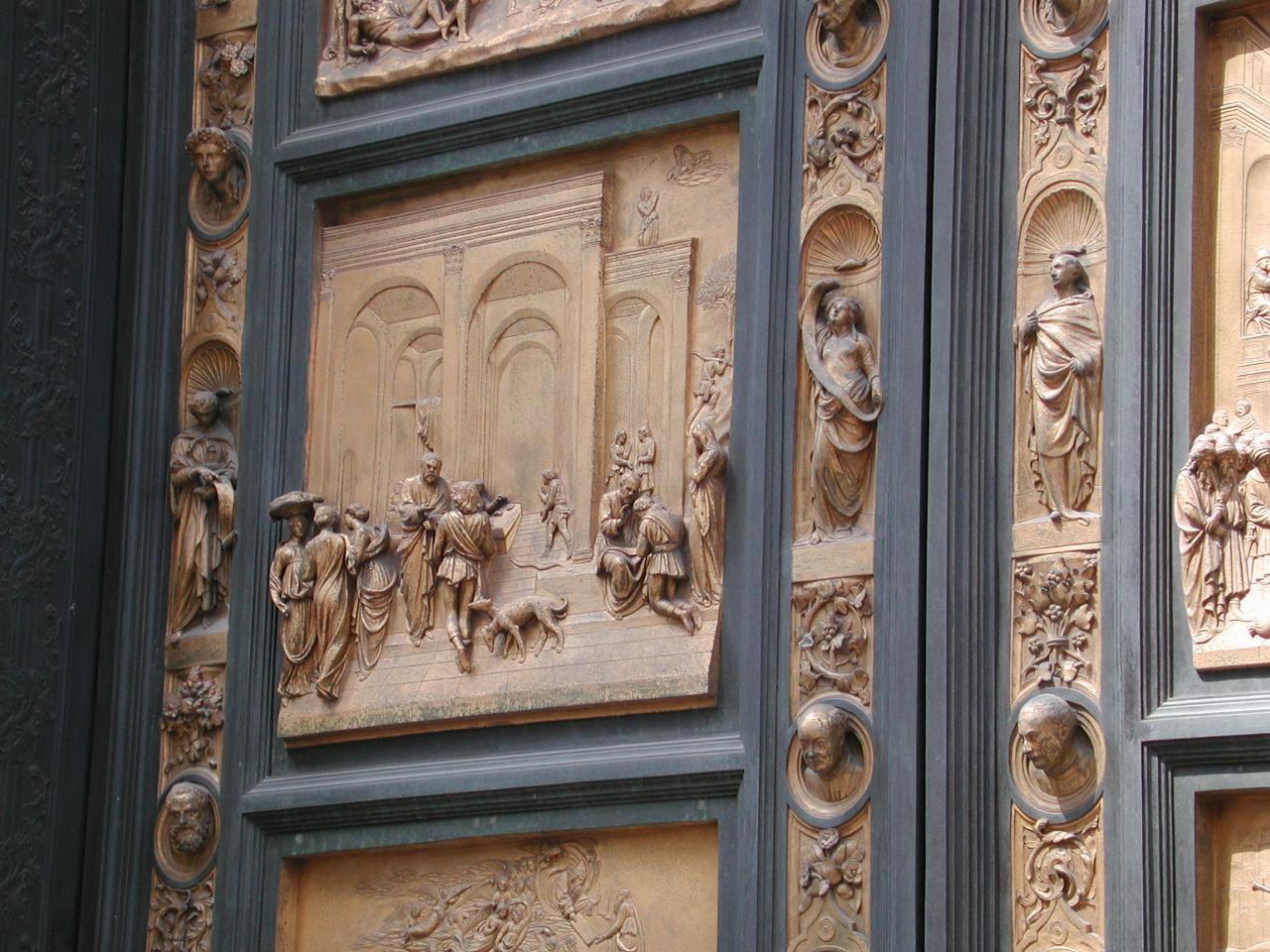 Baptistry doors, with 3 dimensional scenes and two heads are sculptor and his son