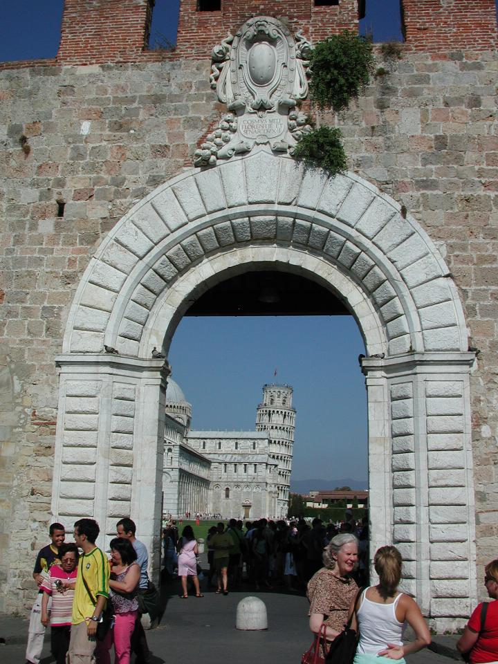 Looking through Pisa City Walls to Cathedral and Leaning Tower