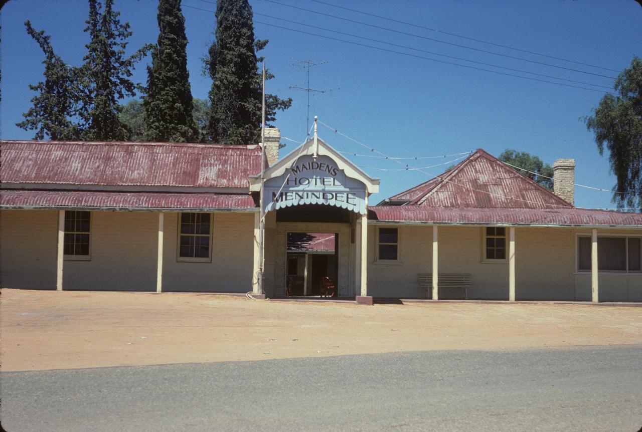 Building with verandah and red tin roof
