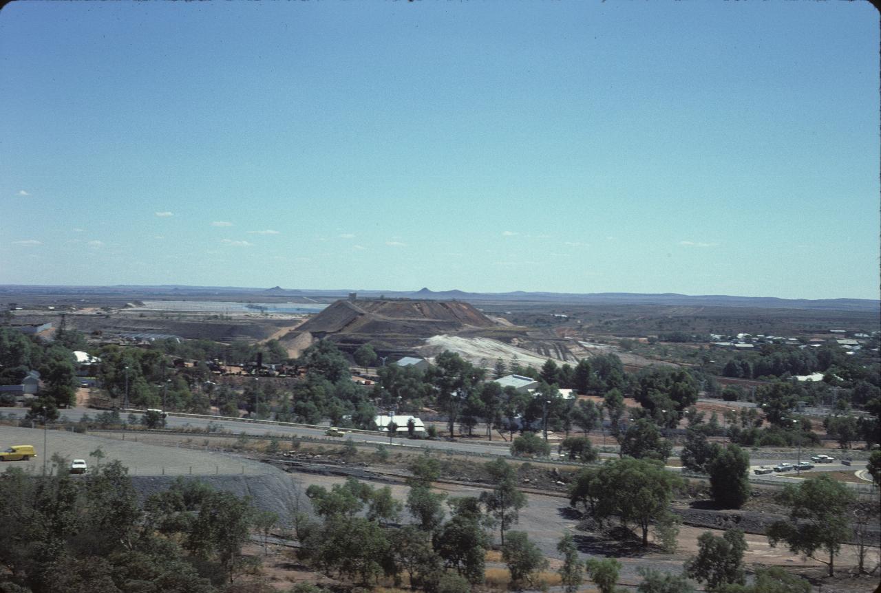 View over mine tailings hill to distant humps