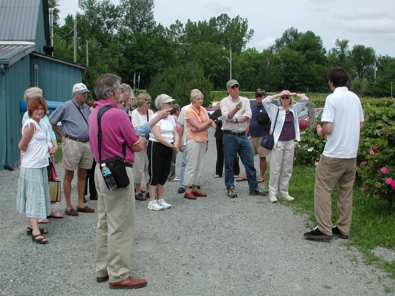 Winery guide talking to KPLU Tour group about vine growing in the region