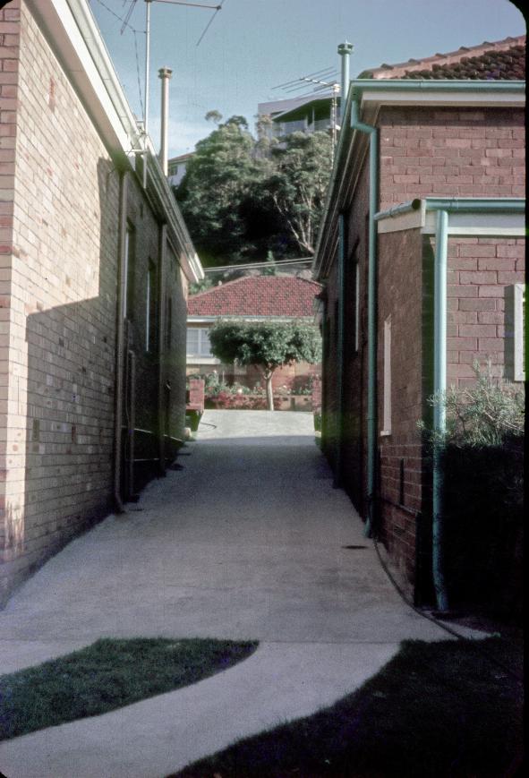 Concrete driveway between two houses