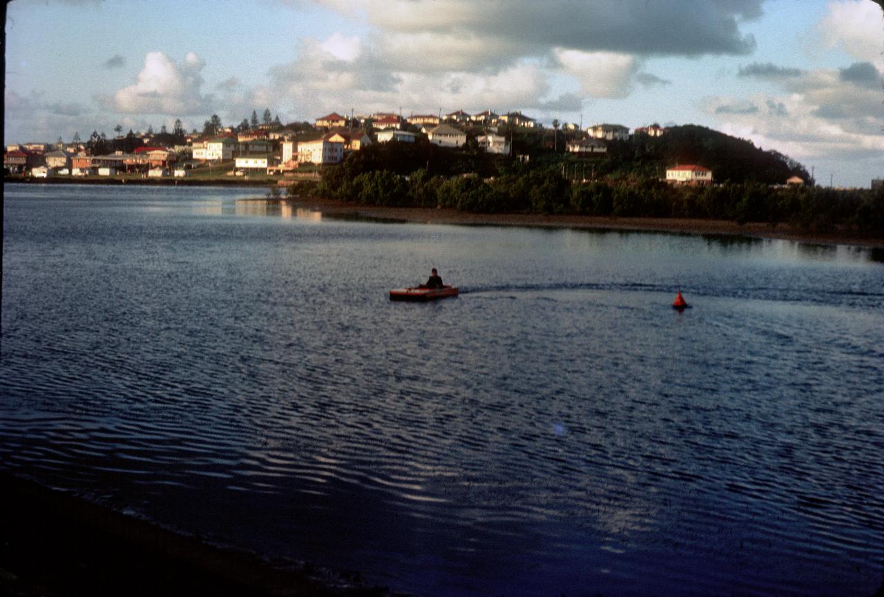 Boy in pedal powered paddle boat on river