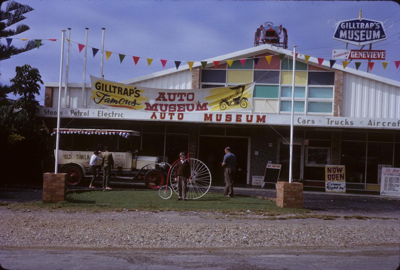 Single storey building with old bus and penny farthing bicycle out front