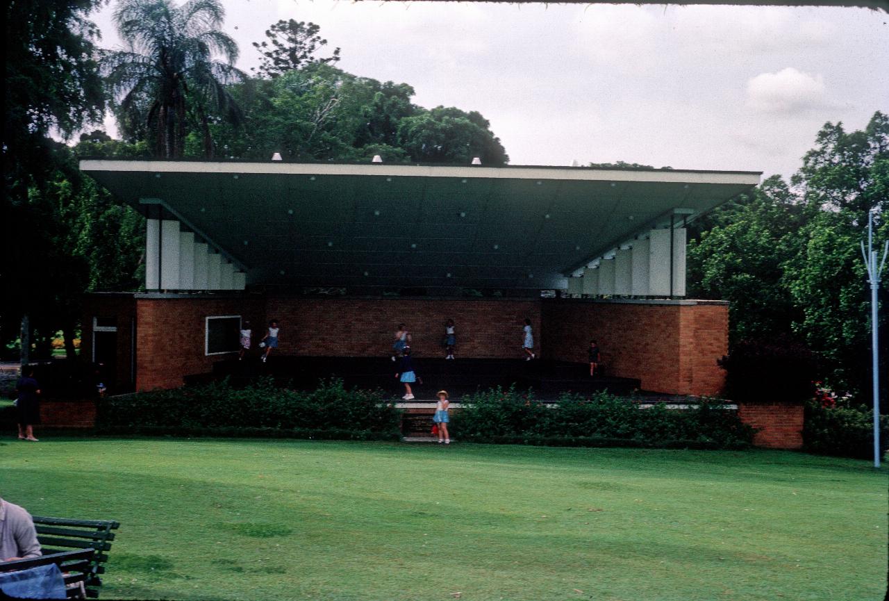 Open air stage with sloping roof and sloping lawn in front