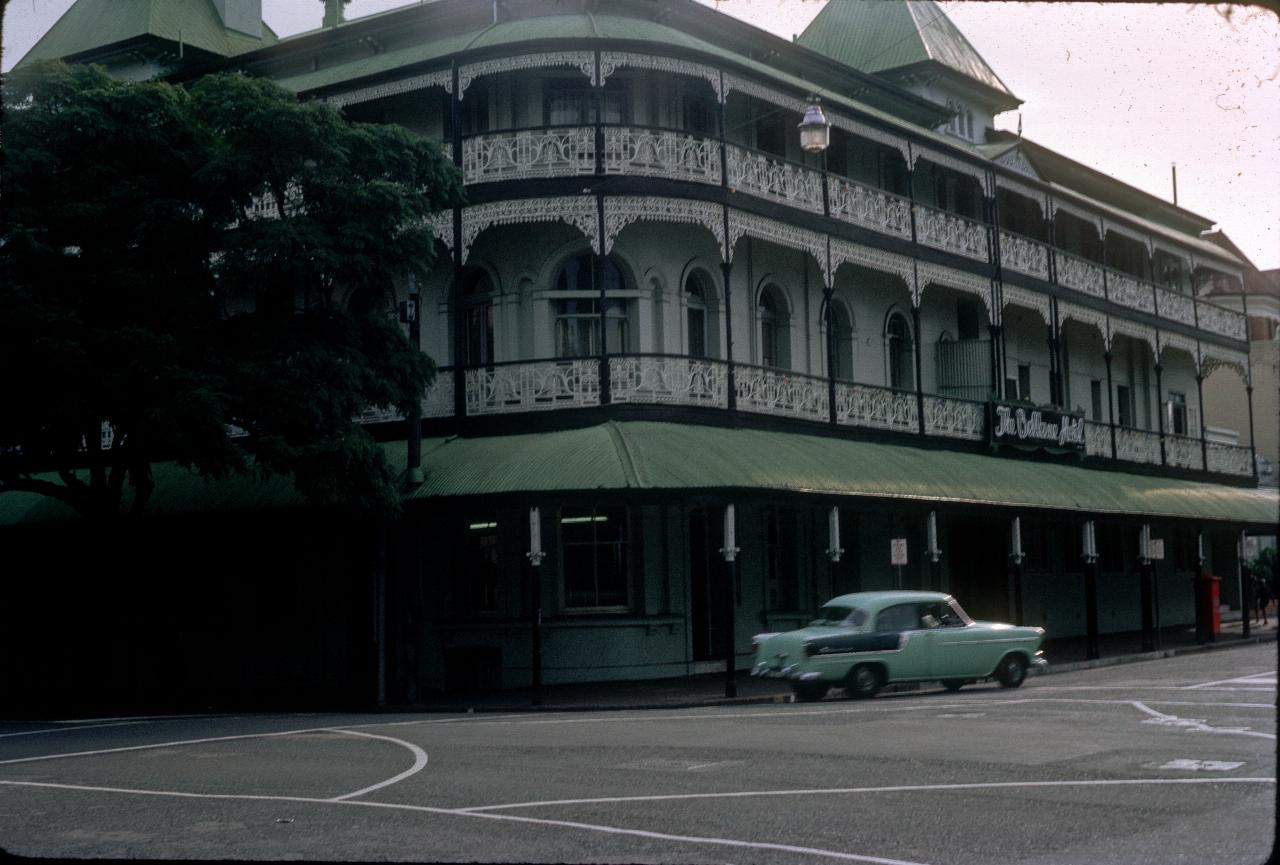 3 storey building with wrought iron balconies wrapping around corner