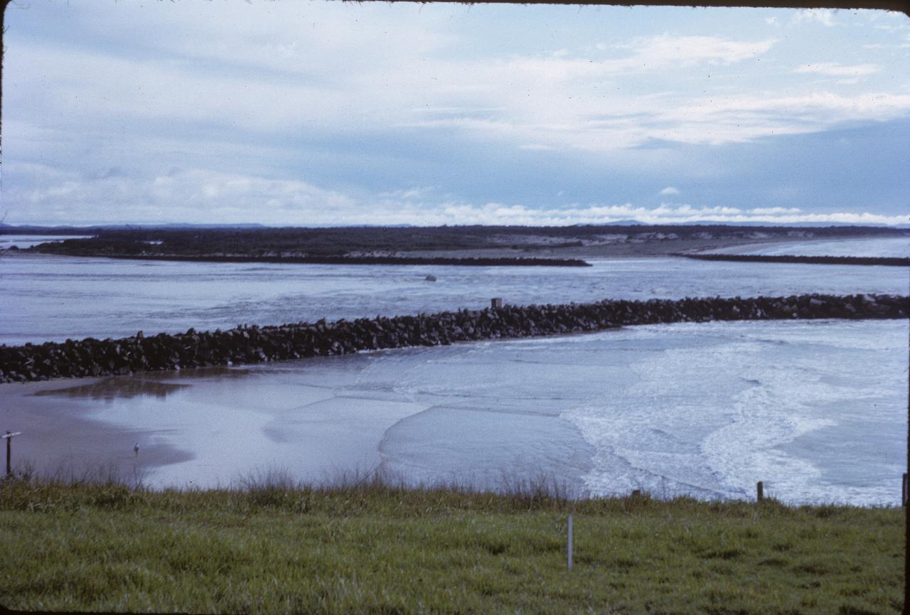 A fishing boat heading out the mouth of the river