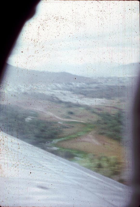 View of city over wing of plane