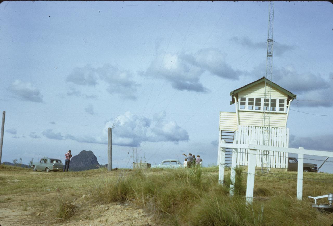 Wooden observatory and cars atop hill