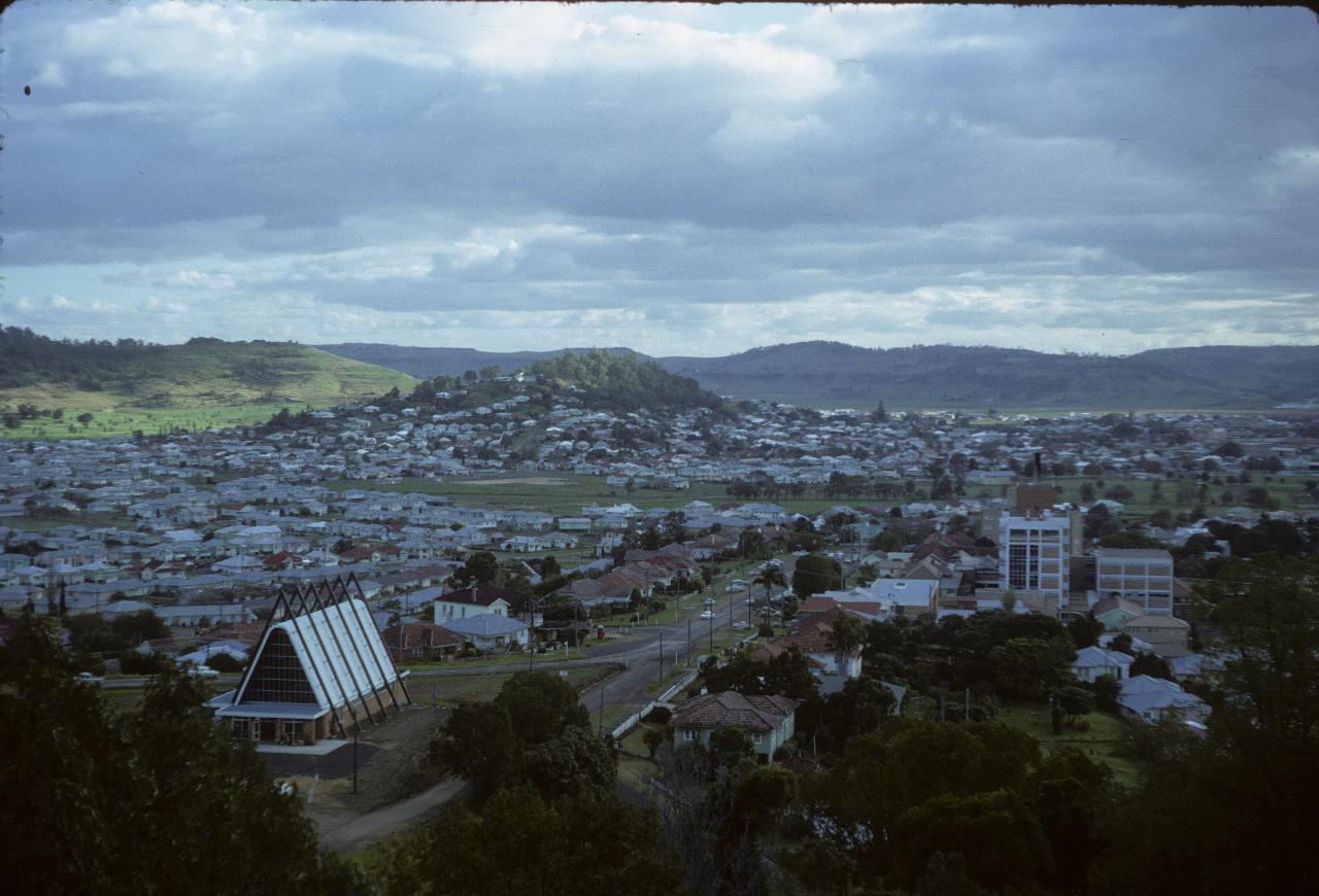 Part of small city with A Frame church and 5 storey building