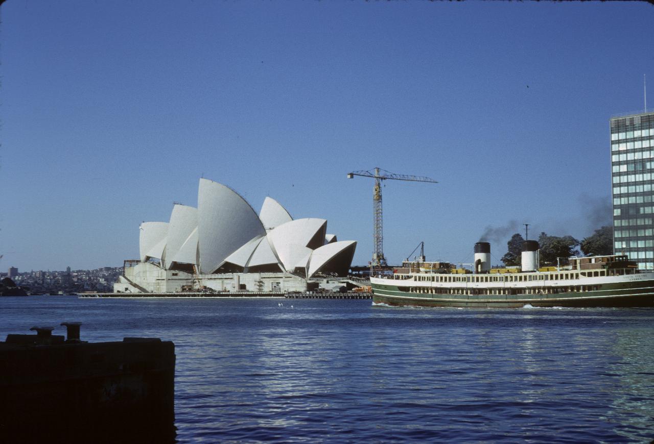 Sydney Opera House under construction with crane