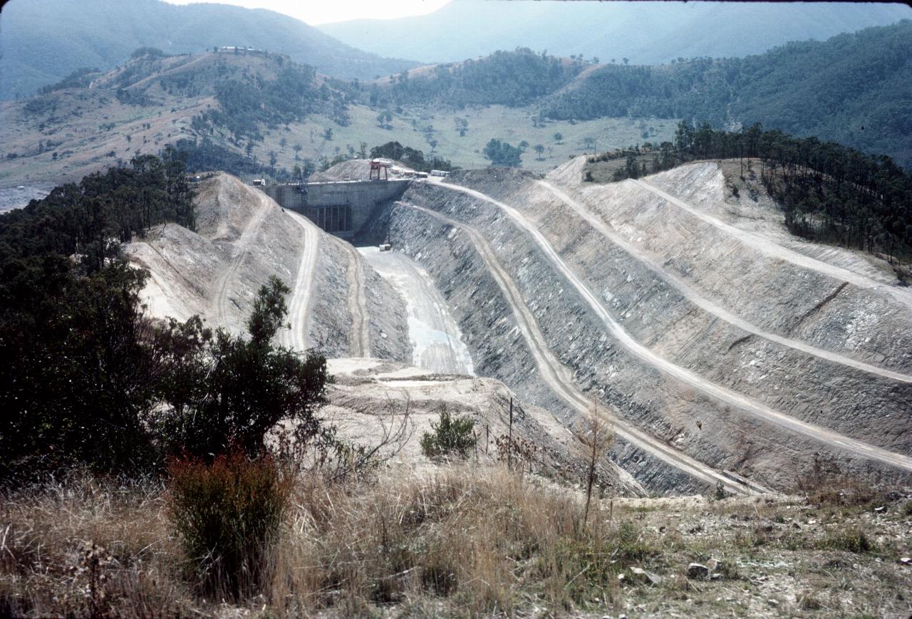 Deep excavated, S shaped channel through hill to concrete control structure