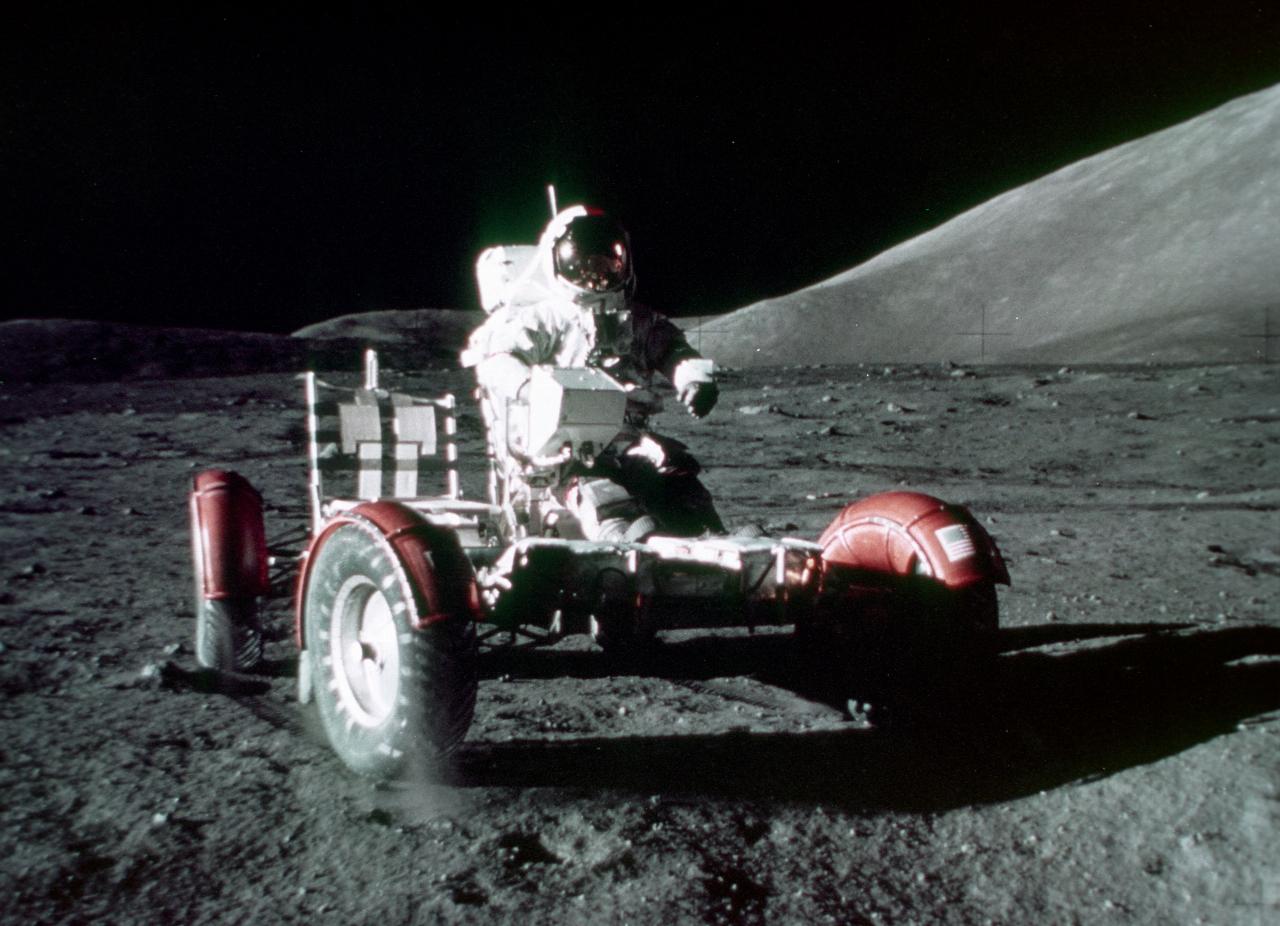 Astronaut driving rover with black background