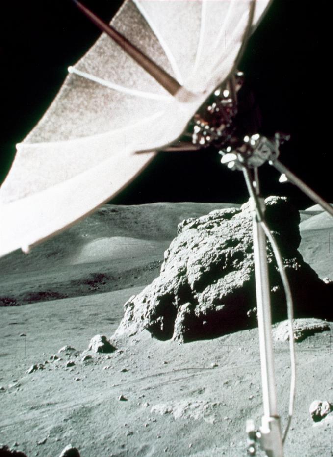 Lunar rock and landscape with rover satellite dish in foreground