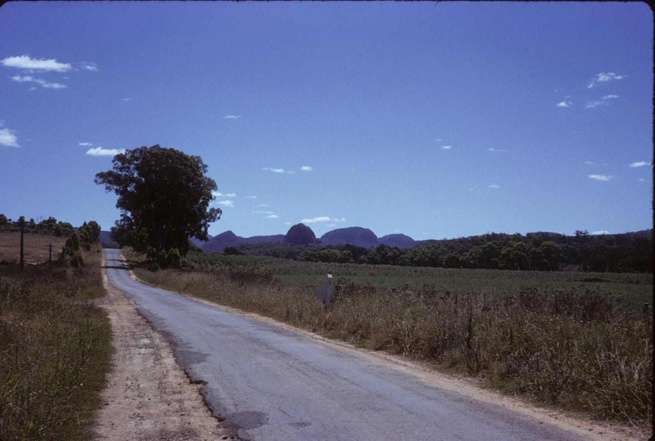 Country road, to farmers field to distant mountains