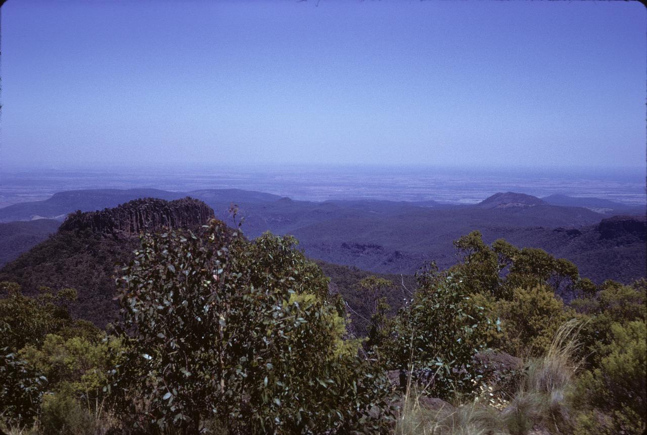 View from mountain over lower hills to plains into the distance