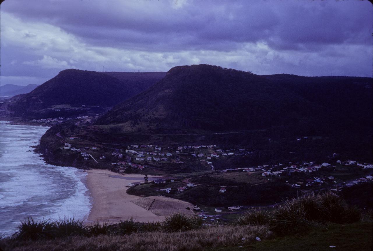 High view down to small town behind beach, with breaking surf