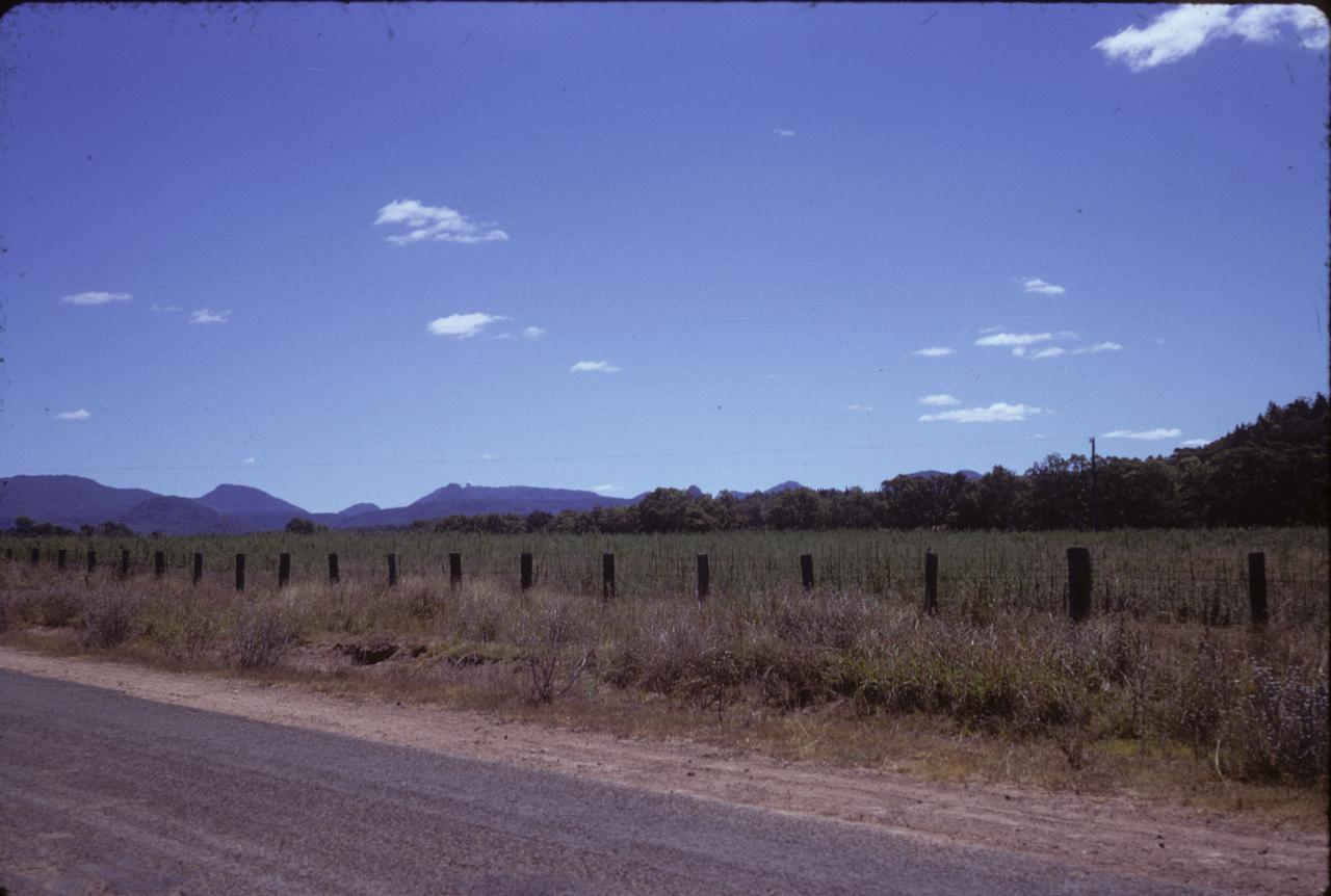 Country road, to farmers field to distant mountains