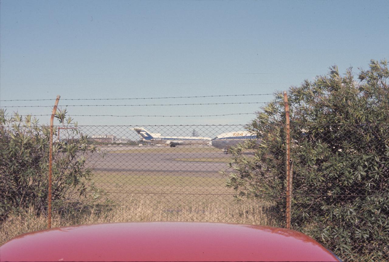 Pair of Boeing 727s behind chain link fence