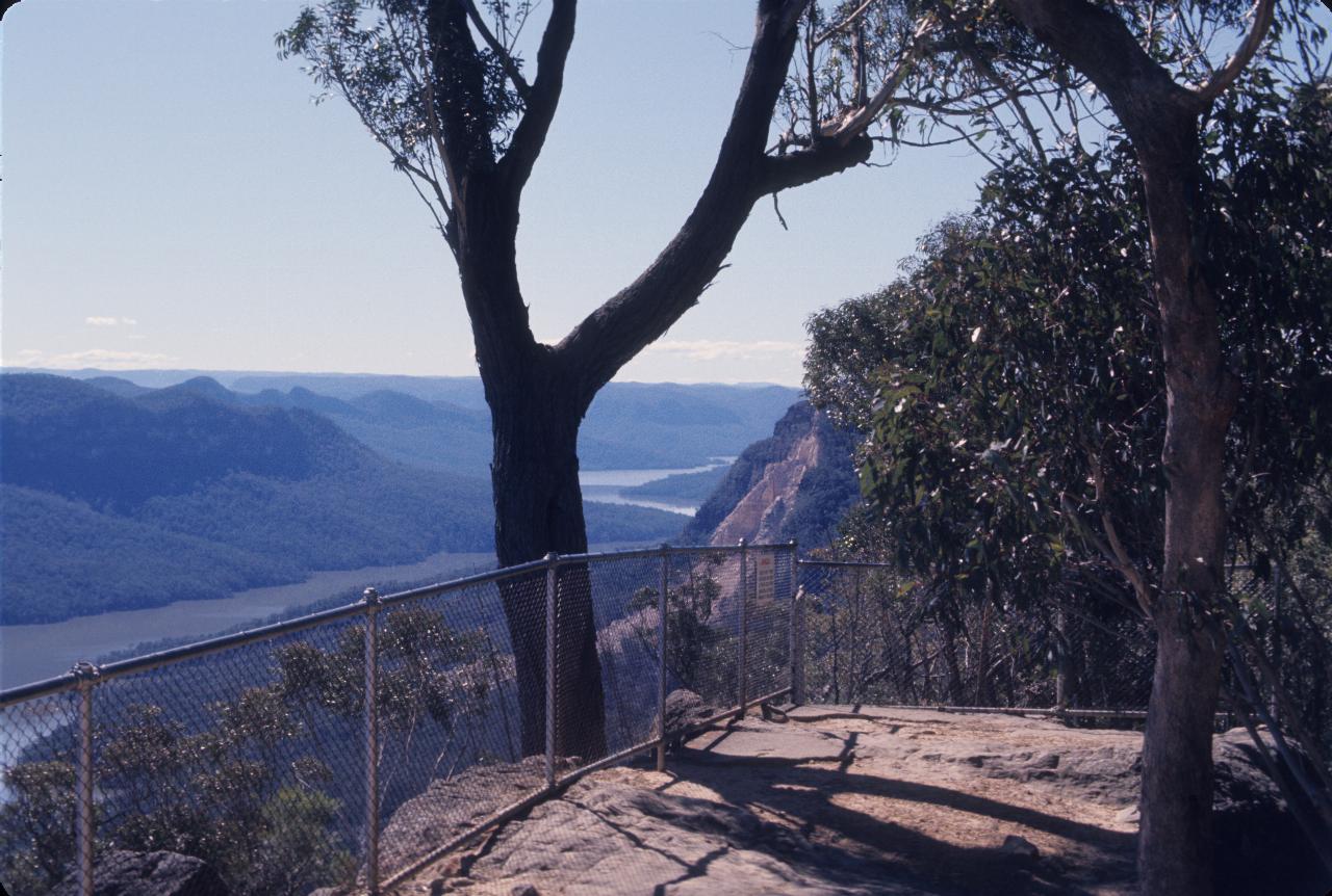 Lookout over flooded valley, with nearby cliff face showing fresh rock