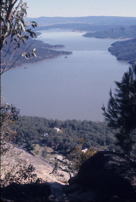 Looking down cliff to buildings below and out towards end of lake