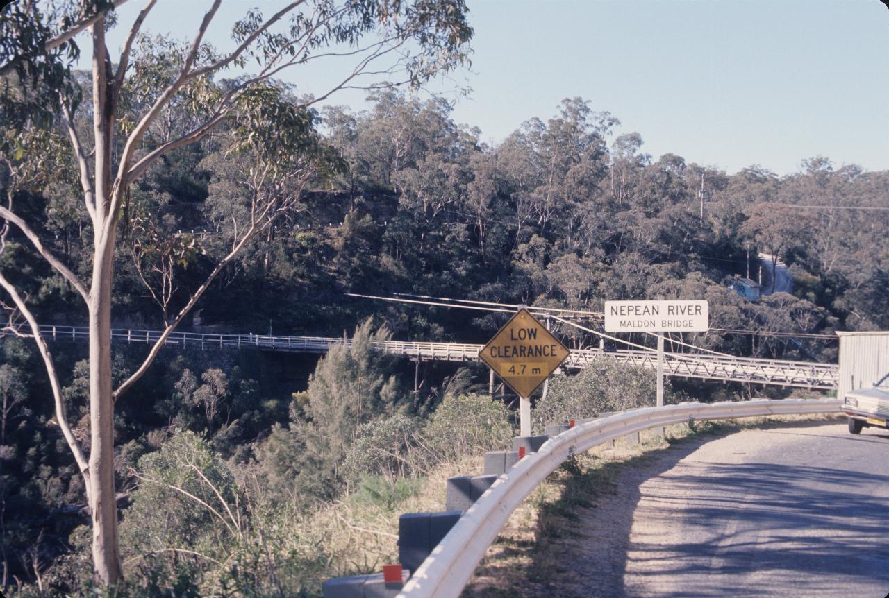 Part of narrow wooden suspension bridge across gorge