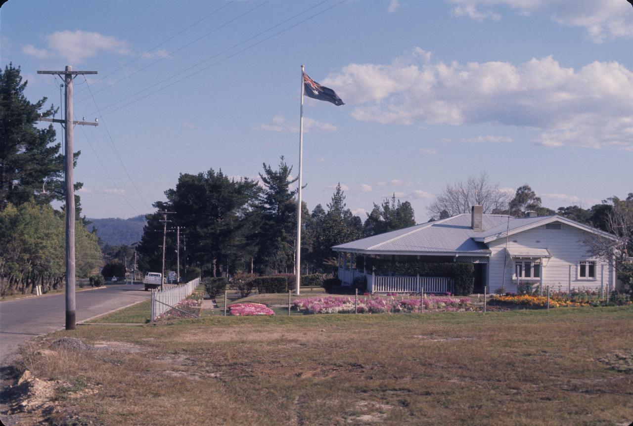 Cottage flying Australian flag, with well kept gardens