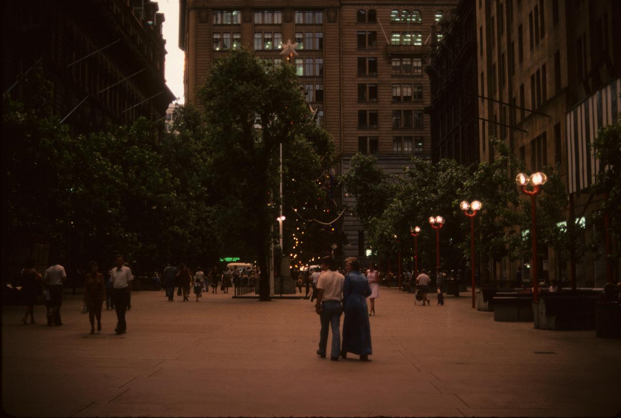 Christmas tree in city plaza, building on 3 sides