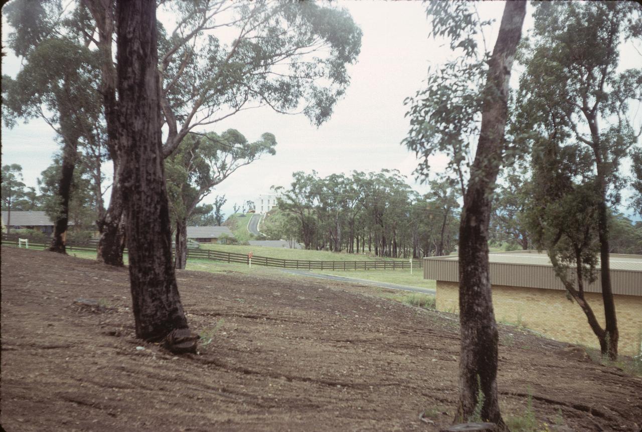 Well maintained grounds, with brick building nearby and telescope dome in distance