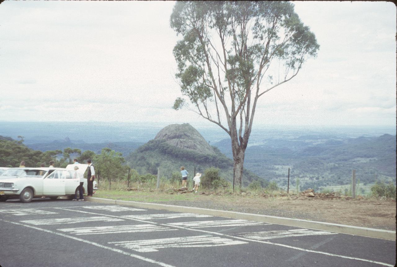 View from parking lot over plains, with triangular peak in mid location