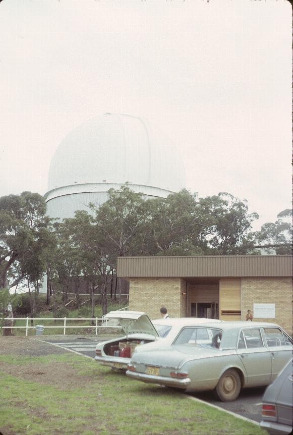 Telescope dome behind trees, seen from parking lot