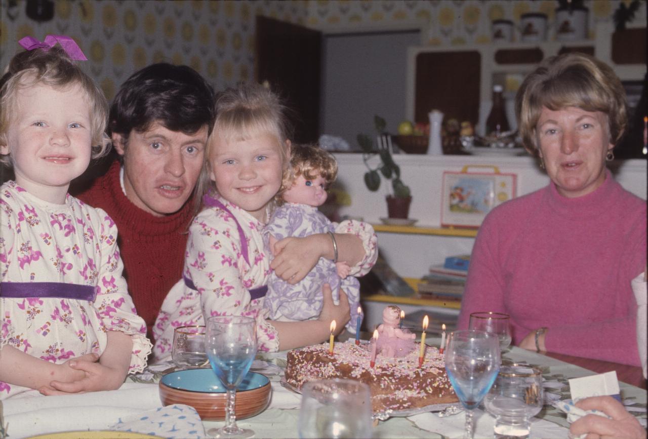 Father with 2 daughters and mother beside them