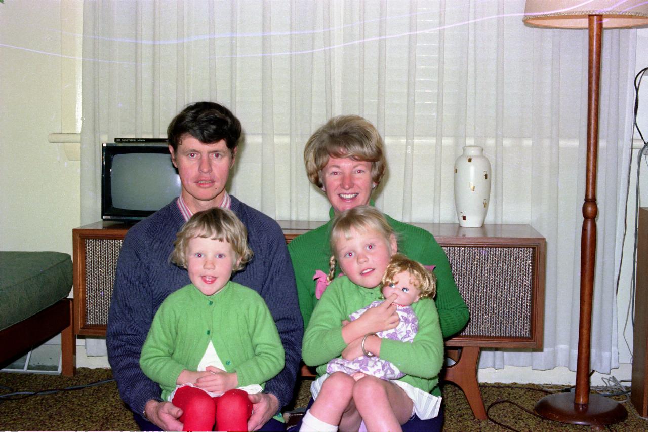 Two adults with 2 little girls on their laps