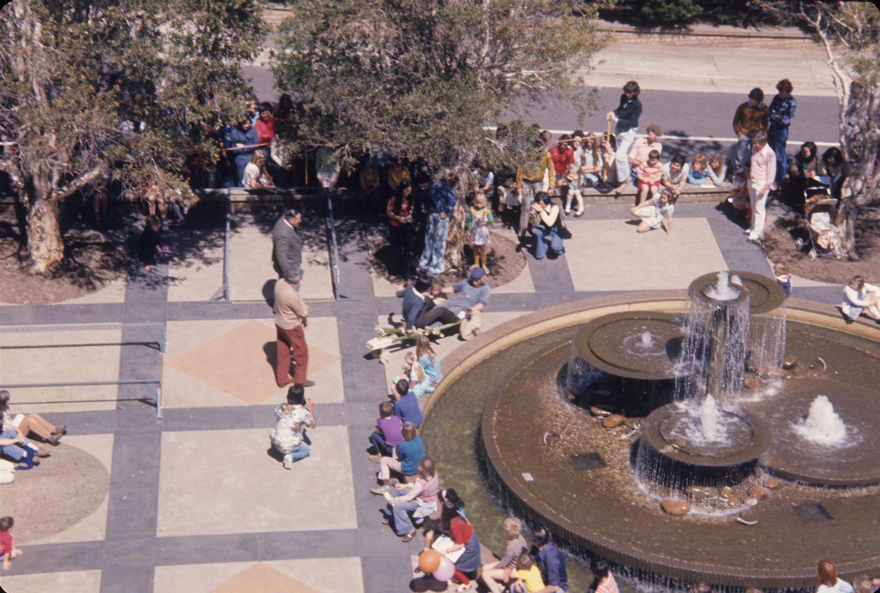 Competitor rounding fountain in plaza, seen from above