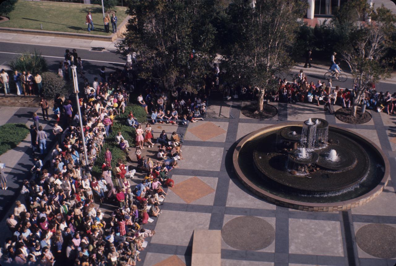 Crowd gathering around plaza with fountain used for Project Flintstone