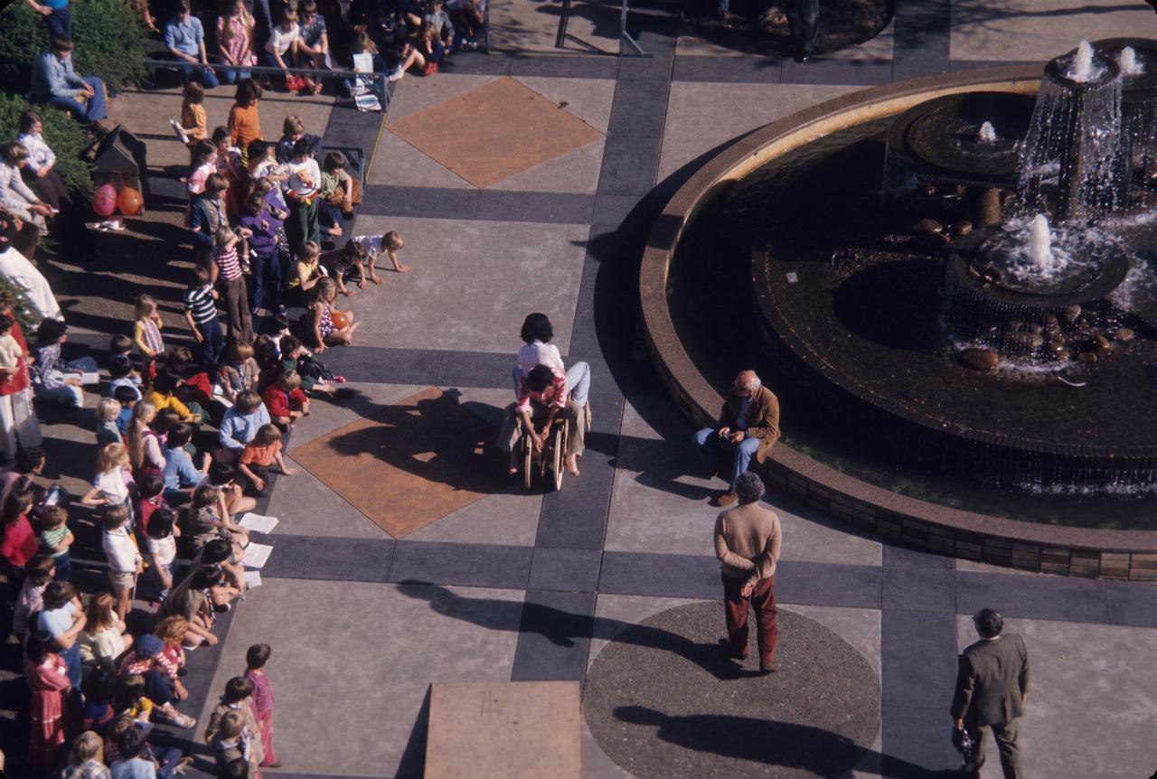 Vehicle passing fountain on way to first parking slot