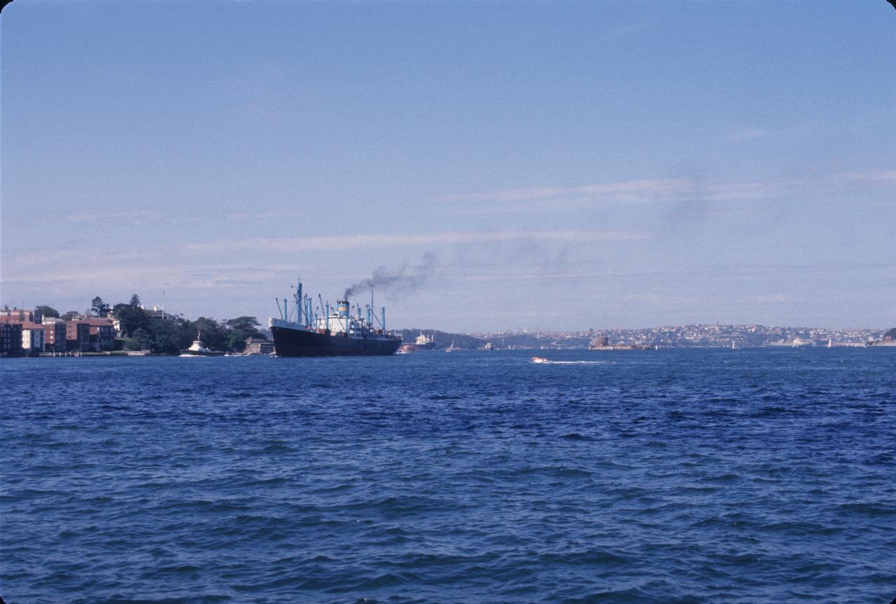 Ship on harbour, with smoke coming from stack